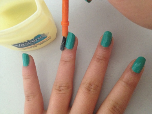 Step 4: Use a small brush or a q-tip to paint a layer of Vaseline around your nail. I went up to the first knuckle. This step is essential! Don't forget to cover the pads of your fingers too. You could use tape as well.
