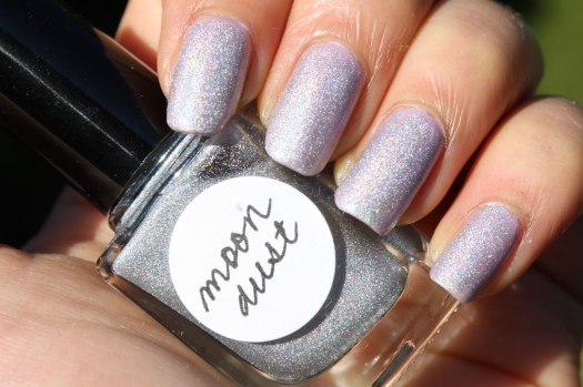 Moondust is a scattered holographic glitter topcoat with a slight linear effect in a clear base